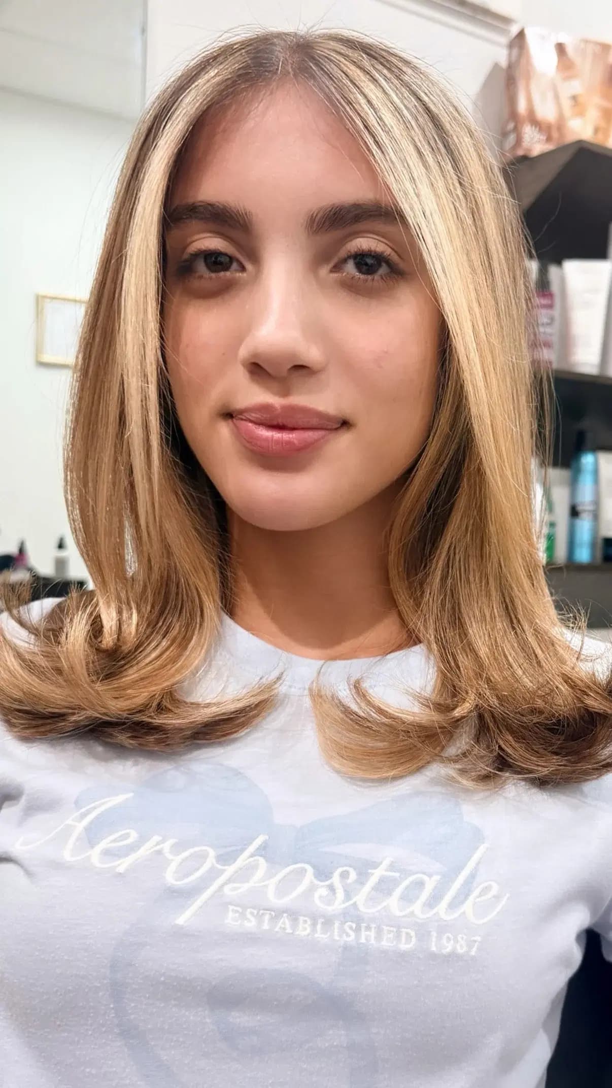 Bright, face-framing blonde on soft shoulder-length layers, finished by Rudy Perez