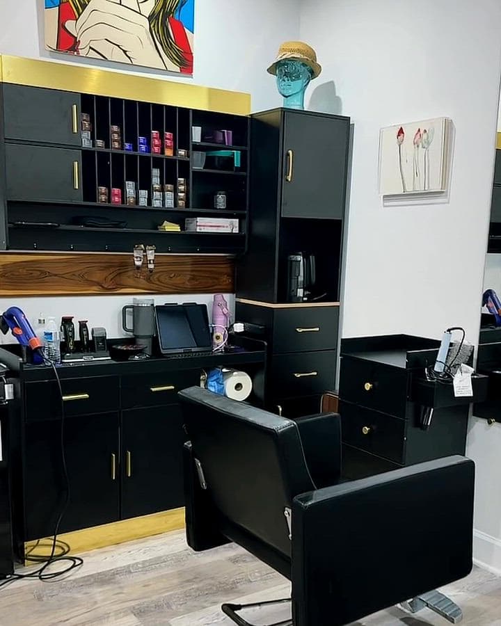 Inside The Real Blossom suite: the styling station, product shelves, lounge, shampoo chair and the gold lotus on the wall